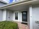 View of the covered front porch with a welcome mat and a well-lit entryway to the home at 12541 Dearborn Dr # B, Hudson, FL 34667