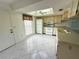 Bright kitchen with tiled flooring, white appliances, and a unique skylight design for ample natural light at 12541 Dearborn Dr # B, Hudson, FL 34667