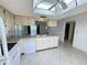 Spacious kitchen with tiled flooring, white appliances, and ample counter space for culinary creations at 12541 Dearborn Dr # B, Hudson, FL 34667
