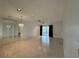 Bright living room with mirrored wall, tile floors, and lanai access at 12541 Dearborn Dr # B, Hudson, FL 34667