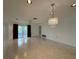 Spacious living room with tile flooring and sliding doors to the lanai at 12541 Dearborn Dr # B, Hudson, FL 34667