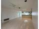 Open floor plan with tile flooring connecting the living room and kitchen at 12541 Dearborn Dr # B, Hudson, FL 34667