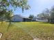 Large backyard showing home, fence, and storage shed at 13010 Siam Dr, Spring Hill, FL 34609