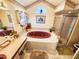 Elegant bathroom featuring a large tub, step in shower, and vanity sink at 13010 Siam Dr, Spring Hill, FL 34609