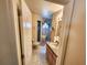 Bright bathroom featuring a walk-in shower, single sink vanity, and neutral tile flooring at 13010 Siam Dr, Spring Hill, FL 34609