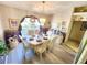 Bright dining room featuring a large window, hanging chandelier, and a neutral color palette at 13010 Siam Dr, Spring Hill, FL 34609