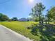 Exterior view of a well-manicured lawn leading up to a charming single-story home at 13010 Siam Dr, Spring Hill, FL 34609