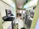 Well-lit kitchen features stainless steel appliances, white cabinetry, and tile flooring at 13010 Siam Dr, Spring Hill, FL 34609