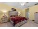 Spacious bedroom featuring a ceiling fan, carpeted floors, and bedside tables with lamps at 13338 Waterleaf Garden Cir, Riverview, FL 33579