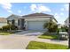 Well-maintained home featuring a neatly landscaped yard and a spacious driveway at 13338 Waterleaf Garden Cir, Riverview, FL 33579