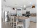 Bright kitchen featuring a large island, granite countertops, and stainless steel appliances at 13338 Waterleaf Garden Cir, Riverview, FL 33579
