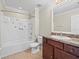 Bathroom featuring a single sink vanity and a tub with shower at 13366 Barkingside Pl, Spring Hill, FL 34609