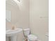 Powder room featuring a pedestal sink and a round mirror at 13366 Barkingside Pl, Spring Hill, FL 34609
