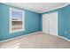 This bedroom features carpeted floors, a window, and a closet with sliding doors at 13366 Barkingside Pl, Spring Hill, FL 34609