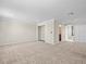 Bonus room featuring neutral carpet, base molding, and walk-in closet at 13366 Barkingside Pl, Spring Hill, FL 34609