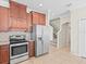 Kitchen showcases stainless steel appliances, ample counter space, and tile flooring at 13366 Barkingside Pl, Spring Hill, FL 34609