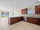 Beautiful kitchen with granite countertops, dark wood cabinets, and stainless steel appliances at 13366 Barkingside Pl, Spring Hill, FL 34609