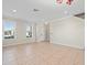 Open concept living space featuring crown molding, tile floors, recessed lighting, and ample natural light at 13366 Barkingside Pl, Spring Hill, FL 34609