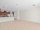 Spacious living room with tile flooring and natural light with kitchen view at 13366 Barkingside Pl, Spring Hill, FL 34609
