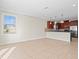 Open living space offers tile floors, a window, and a view into the kitchen at 13366 Barkingside Pl, Spring Hill, FL 34609