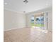 Bright living room with sliding glass doors leading to the backyard at 13366 Barkingside Pl, Spring Hill, FL 34609
