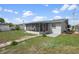 Backyard showcases a screened lanai, providing an inviting outdoor space with a lush lawn at 13700 Allyn Dr, Hudson, FL 34667