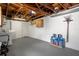 Expansive unfinished basement with laundry appliances and storage solutions at 13700 Allyn Dr, Hudson, FL 34667