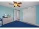The bedroom features wood-look floors, a ceiling fan and large closet at 13700 Allyn Dr, Hudson, FL 34667