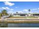 Single story waterfront home featuring a screened lanai and seawall, perfect for enjoying coastal living at 13700 Allyn Dr, Hudson, FL 34667