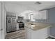 Updated kitchen features stainless steel appliances, granite countertops, and a breakfast bar at 13700 Allyn Dr, Hudson, FL 34667