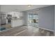 Open kitchen and living space with stainless steel appliances, stone countertops and a view of the canal at 13700 Allyn Dr, Hudson, FL 34667
