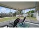 Enclosed lanai features outdoor seating and views of the waterfront at 13700 Allyn Dr, Hudson, FL 34667