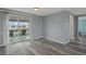 Light and airy living room with sliding glass doors that lead to a screened lanai and water views at 13700 Allyn Dr, Hudson, FL 34667
