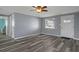 Living room featuring new floors, freshly painted walls, and a new ceiling fan with an exit door at 13700 Allyn Dr, Hudson, FL 34667