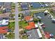 Waterfront property on canal features boat dock, beautiful lawn, and mature palm trees, ideal for coastal living at 15635 Bertram Dr, Hudson, FL 34667