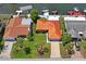 Aerial view of a single-story home with a tile roof nestled among waterfront properties and lush greenery at 15635 Bertram Dr, Hudson, FL 34667