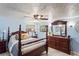 Cozy bedroom with a four-poster bed, dresser, and neutral decor at 15635 Bertram Dr, Hudson, FL 34667