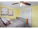 Bedroom with metal frame bed, sliding closet, and painted yellow walls at 15635 Bertram Dr, Hudson, FL 34667