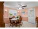 Traditional dining room with wood table, floral curtains, and neutral tile flooring at 15635 Bertram Dr, Hudson, FL 34667