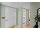 Bright entryway features neutral walls, a white front door, and views into the bathroom and the bedroom at 15635 Bertram Dr, Hudson, FL 34667
