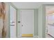 Light and bright entryway featuring neutral walls, an accent painting, and views into the kitchen and bathroom at 15635 Bertram Dr, Hudson, FL 34667