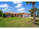 Attractive single-story home with a tile roof, an attached two-car garage, and vibrant landscaping at 15635 Bertram Dr, Hudson, FL 34667