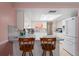 Bright kitchen with modern appliances, a breakfast bar, and granite countertops at 15635 Bertram Dr, Hudson, FL 34667