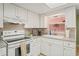 Bright kitchen with modern appliances, dual sinks, granite countertops, and ample cabinet space at 15635 Bertram Dr, Hudson, FL 34667