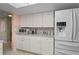 A well-equipped kitchen with white cabinets, granite countertops, and modern appliances at 15635 Bertram Dr, Hudson, FL 34667