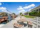 Waterfront patio with mosaic table and seating, stairs to the property and a boat lift at 15635 Bertram Dr, Hudson, FL 34667