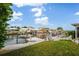 Waterfront property with a private dock, boat lift and canal views under a sunny, blue sky at 15635 Bertram Dr, Hudson, FL 34667