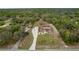 Drone shot of a home showcasing a screened-in patio and detached garage at 18216 Monteverde Dr, Spring Hill, FL 34610