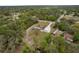 Aerial view of home with a long driveway, lush greenery, and quiet surrounding neighborhood at 18216 Monteverde Dr, Spring Hill, FL 34610