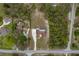 Expansive property featuring a home with large yard, screened in enclosure and extended drive, nestled among mature trees at 18216 Monteverde Dr, Spring Hill, FL 34610